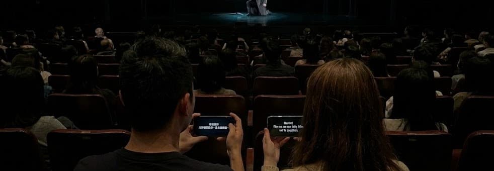 Audience using SurtitleLive on their phones in a theater